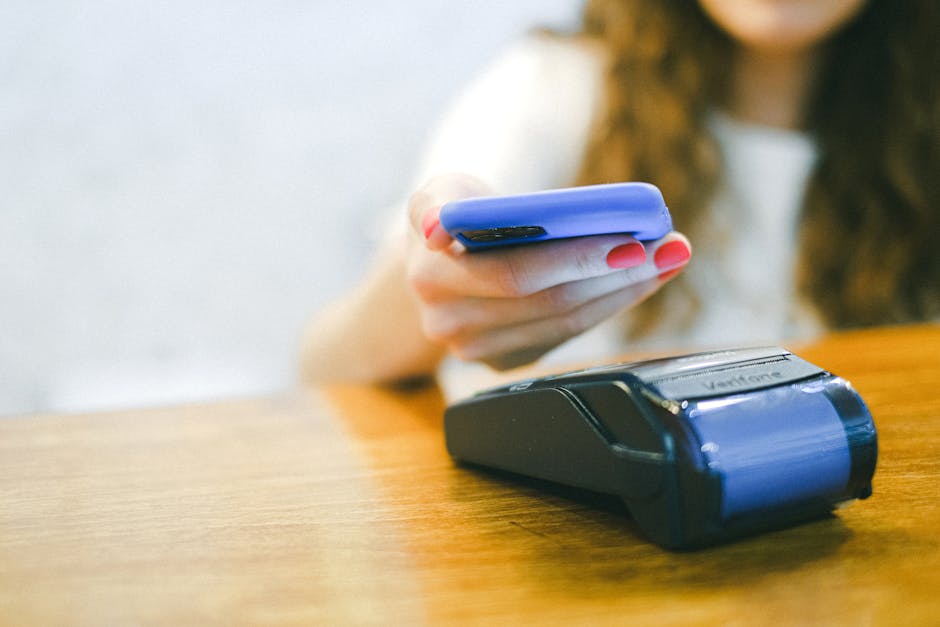 Mulher fazendo pagamento contactless com smartphone em maquina de cartao