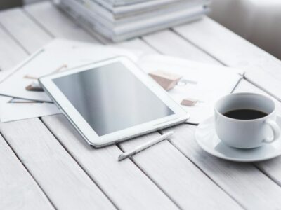 Tablet moderno com stylus e cafe sobre mesa de escritorio, demonstrando versatilidade para estudos, trabalho e lazer em 2026